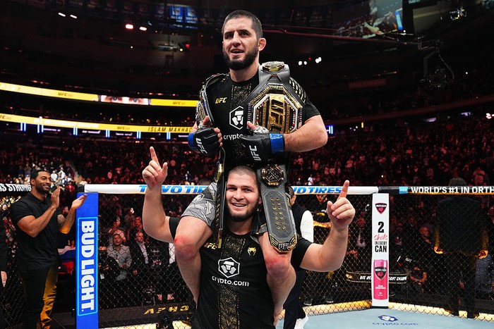 NEW YORK, NEW YORK - NOVEMBER 15: Islam Makhachev of Russia rides on the shoulders of Khabib Nurmagomedov and reacts to his win over Jack Della Maddalena of Australia in the UFC welterweight championship fight during the UFC 322 event at Madison Square Garden on November 15, 2025 in New York City. (Photo by Jeff Bottari/Zuffa LLC)