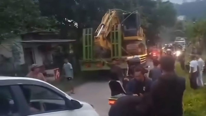 Alat berat yang diangkut truk tersangkut kabel listrik di Bogor