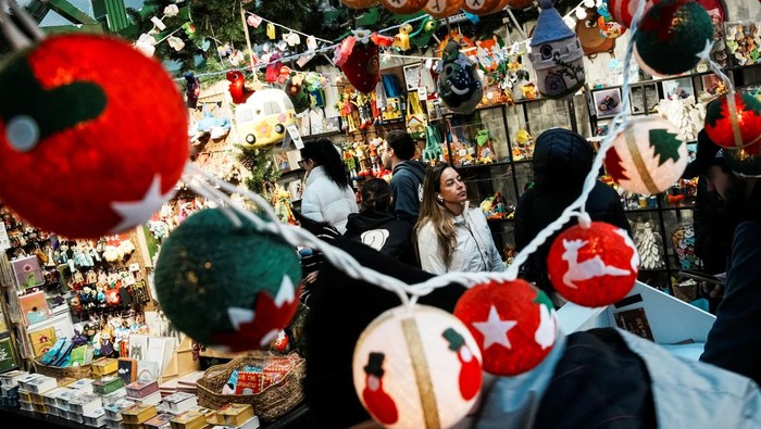 People visit a Christmas store in a holiday market featuring artisans from around the world at Bryant Park in New York City, U.S., November 16, 2025. REUTERS/Eduardo Munoz