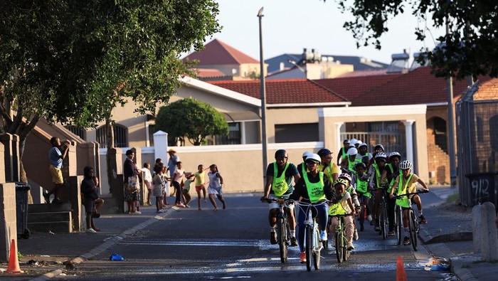 Mzikhona Mgedle, founder of Langa Bicycle Hub, cycles with young riders through the streets of Langa township during an awareness ride, in Cape Town, South Africa, November 7, 2025. REUTERS/Esa Alexander