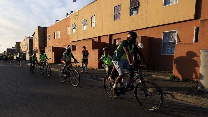 Mzikhona Mgedle, founder of Langa Bicycle Hub, cycles with young riders through the streets of Langa township during an awareness ride, in Cape Town, South Africa, November 7, 2025. REUTERS/Esa Alexander