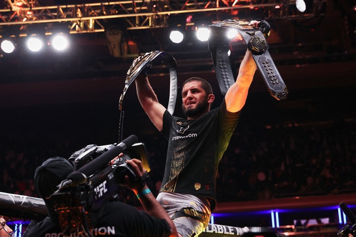 Nov 15, 2025; New York, NY, UNITED STATES; Islam Makhachev (blue gloves) celebrates after defeating Jack Della Maddalena (not pictured) by unanimous decision in the welterweight championship bout during UFC 322 at Madison Square Garden. Mandatory Credit: Ed Mulholland-Imagn Images