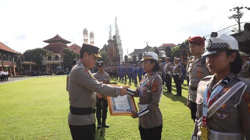 Kapolda Bali, Irjen Daniel Adityajaya, menyerahkan penghargaan kepada personel berprestasi di halaman depan kantornya, Senin,(17/11/2025). (Dok. Polda Bali)