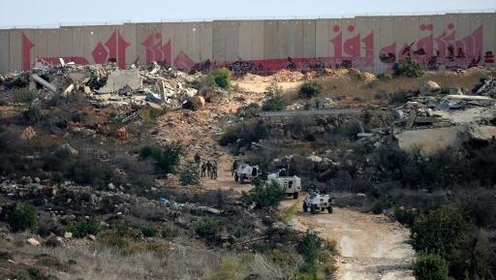 Troops from the United Nations Interim Force in Lebanon (UNIFIL) patrol near the southern Lebanese border village of Kfar Kila on November 12, 2025. Israel has recently intensified its strikes on Lebanon, accusing the Iran-backed Hezbollah group of rearming, nearly a year into a ceasefire that brought an end to their most recent war. (Photo by Rabih DAHER / AFP)