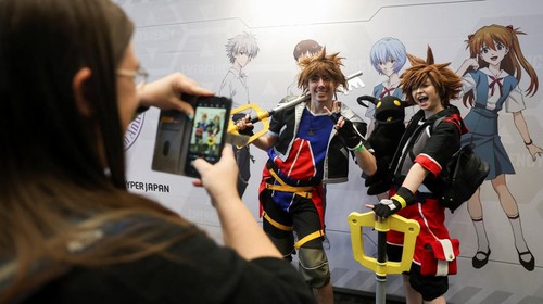 Visitors check an exhibition of anime art during Hyper Japan, a major festival showcasing Japanese culture taking place at the Manchester Central Convention Complex, in Manchester, Britain, November 16, 2025. REUTERS/Temilade Adelaja