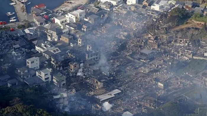 Smoke rises from a site where a massive fire blazed through more than 170 buildings, as seen from a helicopter, in Oita, Oita Prefecture, southwestern Japan, November 19, 2025, in this photo taken by Kyodo. (Reuters)