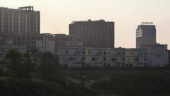 A view of Shwe Kokko town in Myanmars Myawaddy district in Kayin State is seen from Thailands Mae Sot district in Tak province on February 11, 2025. More than 250 people rescued from online scam centres in Myanmar were handed over to Thailand on February 12, a senior Thai army official said, following a series of crackdowns on the illegal operations. Shwe Kokko, one of the most notorious scam compounds on the Myanmar side, is a built-up city, and security has been tightened in the area, with several Thai military checkpoints and signs warning of Thais and foreigners being 