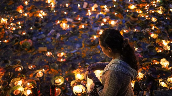 A Nepali Hindu devotee floats live oil-fed lamps in the sacred Bagmati River in Kathmandu, Nepal, on November 19, 2025, during Bala Chaturdashi, a festival to give salvation to departed souls. In remembrance of beloved ones, Nepali Hindu devotees offer oil-fed lamps into the Bagmati River flowing through the premises of Pashupatinath Temple in Kathmandu on the day of Bala Chaturdashi. The live lamps float on the river, which is believed to lighten the world of departed souls in their afterlife. Devotees remain awake throughout the night, camping on the edge of the Bagmati River facing the Pashupatinath Temple. Rituals for Bala Chaturdashi start from Marga Krishna Trayodashi, the 13th day of the waning moon in the month of Mangsir (8th month according to the Nepali calendar). Devotees who observe this ritual maintain strict fasting, with only one meal that day and abstain from garlic, onions, fish, eggs, and other food items that are said to be impure. In the evening, they reach the Pashupatinath temple or shrines dedicated to Lord Shiva and chant hymns and prayers to Lord Shiva all night long. They light ''Akhanda Jyoti'' in the name of the deceased souls of their families. The next morning, Marga Krishna Chaturdashi, they take a holy bath and start their journey around the Pashupatinath temple premises, spreading seven kinds of grains along the way. The seven grains (also called Satbeej) include dhaan (rice), jau (barley), til (sesame), gahun (wheat), chana (chickpeas), makai (maize), and kaguno (foxtail millet). Devotees walk along Kailash-Suryaghat-Gaurighat-Aryaghat-Guhyeshwari-Mrigasthali-Bishworup-Kirateshwar-108 Shivalinga. (Photo by Subaas Shrestha/NurPhoto via Getty Images)