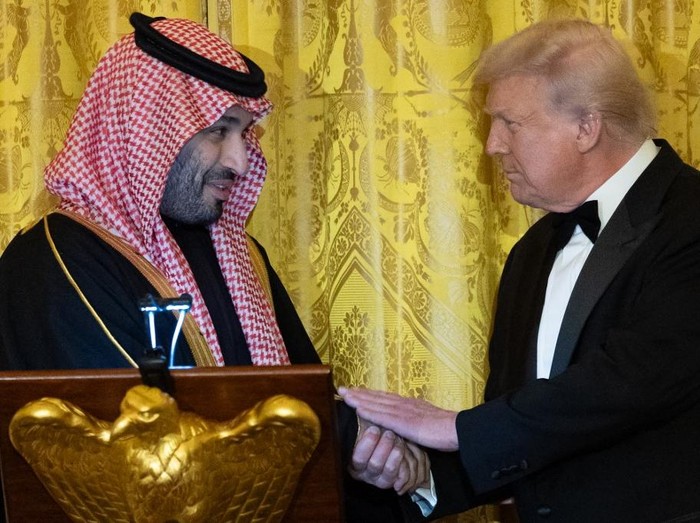 WASHINGTON, DC - NOVEMBER 18: Crown Prince and Prime Minister Mohammed bin Salman of Saudi Arabia (L) shakes hands with U.S. President Donald Trump during a dinner in the East Room at the White House on November 18, 2025 in Washington, DC. Trump is hosting the Crown Prince for meetings aimed at strengthening economic and defense ties, including the U.S. sale of F-35 fighter jets to Saudi Arabia.   Win McNamee/Getty Images/AFP (Photo by WIN MCNAMEE / GETTY IMAGES NORTH AMERICA / Getty Images via AFP)