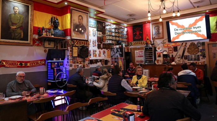 Patrons eat and drink at the Spanish dictator Francisco Franco themed tapas restaurant 'Una Grande Libre' decorated with nationalist, fascist, Falangist and Francoist symbols, in Madrid, Spain, November 10, 2025. November 20, 2025 marks the 50th anniversary of Francisco Franco’s death. In a quiet corner of Madrid, the late Spanish dictator Francisco Franco’s image still presides over dinner at 'Una Grande Libre'. The restaurant, owned by a Chinese Spanish entrepreneur, has become a curious relic of Spain’s, authoritarian past, where portraits, memorabilia, and menus echo an era many thought buried.  REUTERS/Violeta Santos Moura