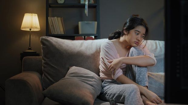 1358059835 Asian Teenager Boring while watching tv at home in the nighttime.