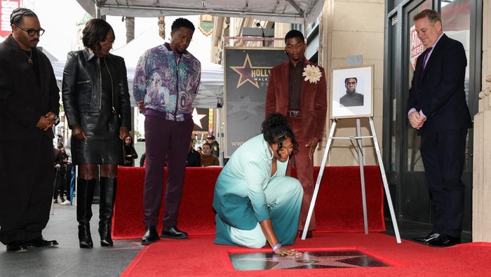 A photo of late filmmaker Chadwick Boseman sits next to a pair of shoes on his unveiled star on the Hollywood Walk of Fame in Los Angeles, California, U.S., November 20, 2025. REUTERS/Mario Anzuoni