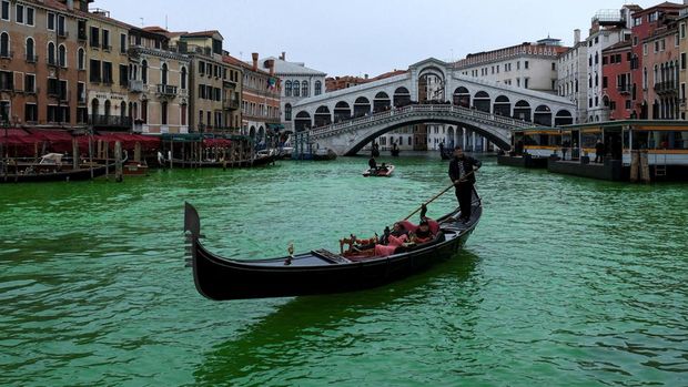The Grand Canal, where the canal's water has been dyed green in a protest organised by the 