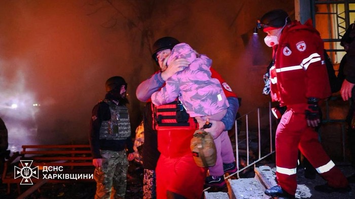 A medical worker evacuates a child from the apartment building hit by a Russian drone strike, amid Russia's attack on Ukraine, in Kharkiv, Ukraine in this handout picture released November 19, 2025. Press service of the State Emergency Service of Ukraine in Kharkiv region/Handout via REUTERS ATTENTION EDITORS - THIS IMAGE HAS BEEN SUPPLIED BY A THIRD PARTY. MUST NOT OBSCURE LOGO.