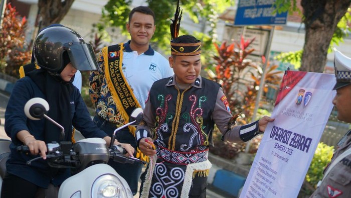 Pakai Baju Adat, Satlantas Polres Pasuruan Kota Beri Coklat bagi Pengendara Tertib