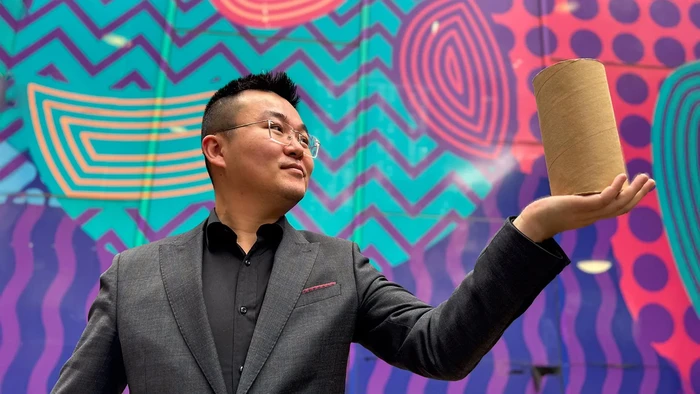 Dr. Jiaming Ma, sedang memegang material tanah padat yang dipadatkan dalam kardus.