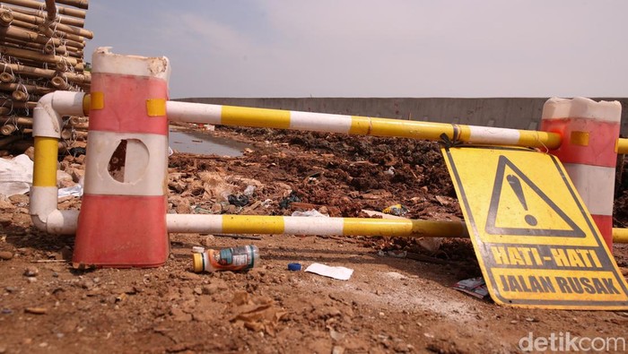 Sejumlah pekerja terlihat membangun taman di kawasan tanggul Pelabuhan Muara Baru pada Jumat (28/11/2025).