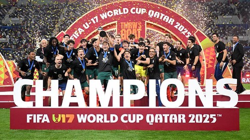 DOHA, QATAR - NOVEMBER 27: Rafael Quintas of Portugal lifts the FIFA U17 Mens World Cup trophy with teammates following the teams victory in the FIFA Under-17 World Cup final match between Portugal and Austria at Khalifa International Stadium on November 27, 2025 in Doha, Qatar. (Photo by Jurij Kodrun - FIFA/FIFA via Getty Images)