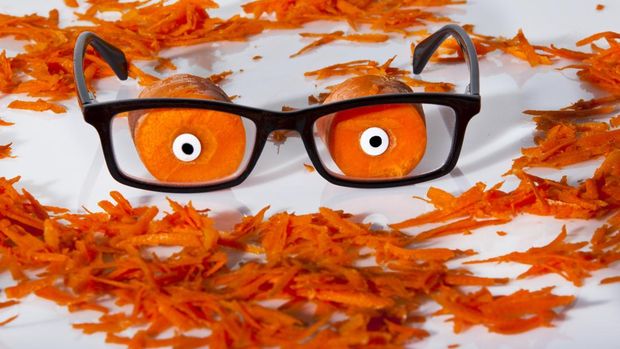 470959480 Funny photo showing how carrots improve your vision by having eyes on carrots with a pair of reading glasses