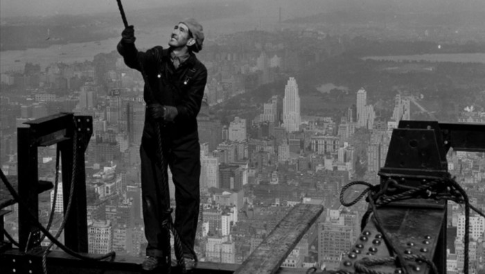 Kuli proyek zaman dulu yang bekerja tanpa alat keselamatan.