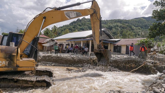 Pekerja mengoperasikan alat berat saat membersihkan material banjir bandang dan tanah longsor di Nagari Guguak Malalo, Kabupaten Tanah Datar, Sumatera Barat, Selasa (2/12/2025).  Akses menuju Nagari Padang Laweh dan Guguak Malalo sempat terputus dari wilayah sekitar, sehingga proses evakuasi warga dilakukan melalui jalur Danau Singkarak. ANTARA FOTO/Wawan Kurniawan/Lmo/bar