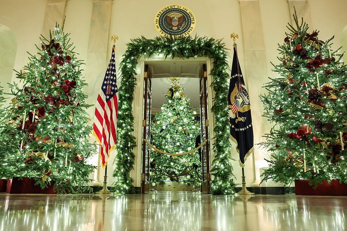 WASHINGTON, DC - DECEMBER 01: Christmas trees and holiday decorations surround the Cross Hall during an advance tour of the 2025 White House Christmas decorations on December 01, 2025 in Washington, DC. The theme for this years White House Christmas decorations is Home Is Where The Heart Is. (Photo by Anna Moneymaker/Getty Images)