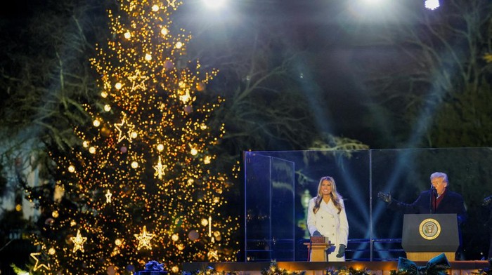 U.S. President Donald Trump speaks next to first lady Melania Trump, after lightning the National Christmas Tree during a ceremony at the White House in Washington, D.C., U.S., December 4, 2025. REUTERS/Jonathan Ernst