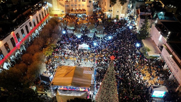 A drone view of Palestinians lighting up a Christmas tree in Manger Square outside the Church of the Nativity, in Bethlehem, in the Israeli-occupied West Bank, December 6, 2025. REUTERS/Yosri Aljamal