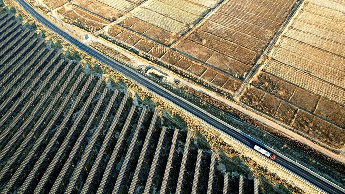 WUZHONG, CHINA - DECEMBER 08: An aerial view shows of rows of solar panels delivering green electricity on the Gobi Desert on December 8, 2025 in Wuzhong, Ningxia Hui Autonomous Region of China. In recent years, Ningxia has fully utilized land resources such as deserts and wastelands to develop the clean energy industry, underscoring its commitment to benefit the environment and the local community. (Photo by Zhou Xupeng/VCG via Getty Images)