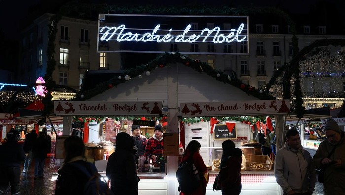 People visit a Christmas market in Nantes, France, December 9, 2025. REUTERS/Stephane Mahe