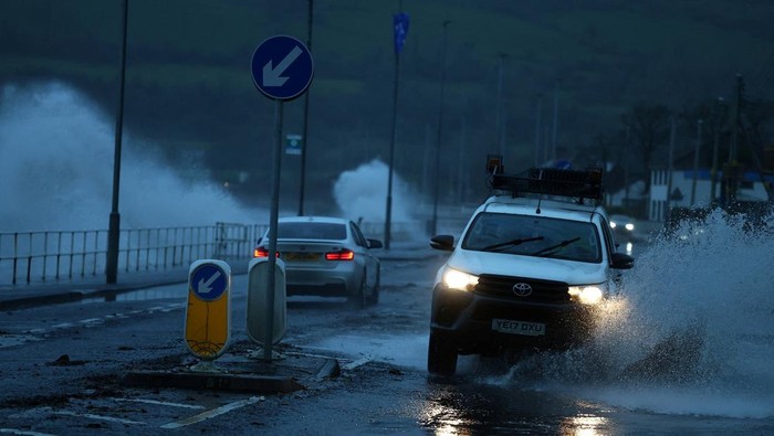 Waves crash against the sea wall as Storm Bram brings widespread weather warnings, heavy rain and high winds across the United Kingdom, in Carnlough, Northern Ireland December 9, 2025. REUTERS/Cathal McNaughton