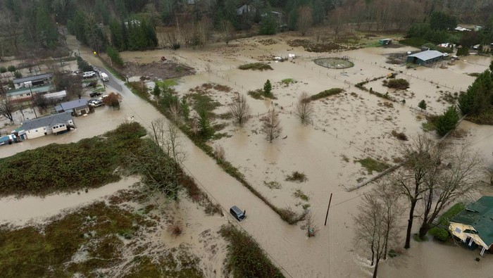 A drone view shows a vehicle stranded in an area flooded by the Wallace River, as an atmospheric river brings rain and flooding to the Pacific Northwest, in Gold Bar, Washington, U.S., December 10, 2025. REUTERS/David Ryder