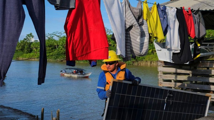 Elba Ferreira's family house is illuminated after the installation of solar panels in their home on the banks of the Amazon River, as part of Brazil's 