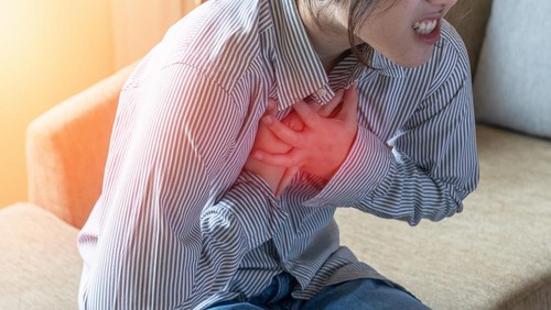 Chest pain illness causing heart attack and stroke, cardiac disease risk in young woman, atrial fibrillation awareness month, heartburn or cardiovascular heart health illness problem