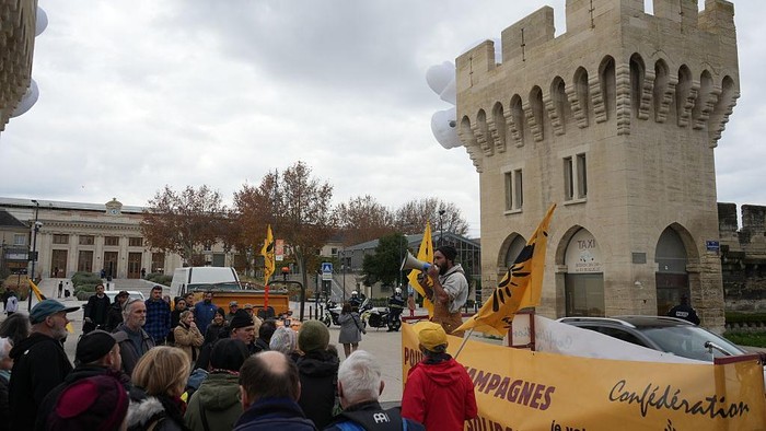 AVIGNON, FRANCE - DECEMBER 15: More than a hundred farmers from the Confederation Paysanne unions rally in Avignon to denounce the French government's handling of contagious nodular dermatitis in cattle, opposing mass herd culls and calling for increased use of vaccination, on December 15, 2025. Demonstrators, including tractors and farm vehicles, gathered outside the local prefecture to protest sanitary protocols requiring the slaughter of entire herds when the disease is detected. (Photo by Mathieu Prudhomme/Anadolu via Getty Images)