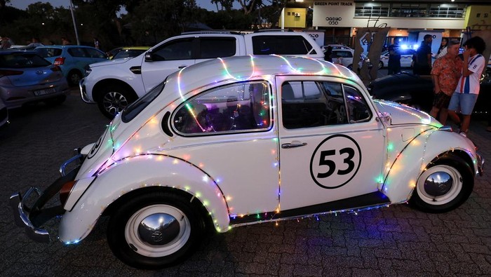 A man dressed as the Grinch poses on a car decorated with Christmas lights during Christmas season in Cape Town, South Africa, December 14, 2025. REUTERS/Esa Alexander