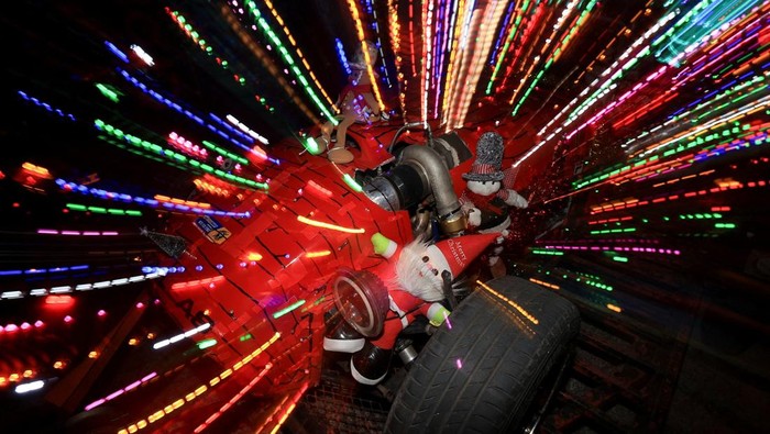 A man dressed as the Grinch poses on a car decorated with Christmas lights during Christmas season in Cape Town, South Africa, December 14, 2025. REUTERS/Esa Alexander