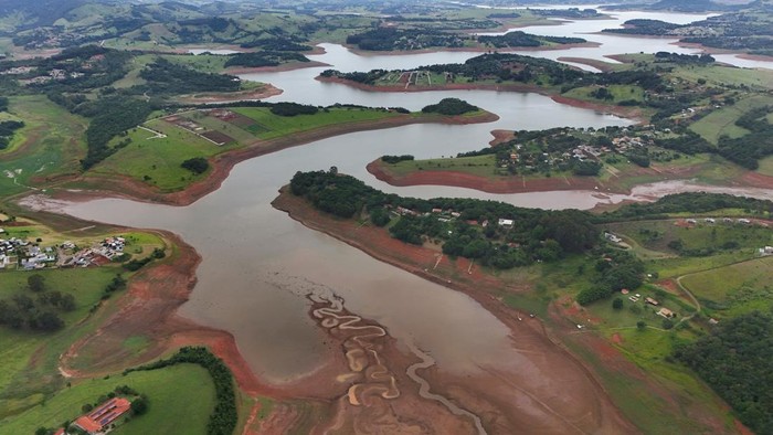 A drone view shows dried channels and green patches on the exposed surface of Jaguari dam during its lowest level in a decade, according to data from Brazilian water and waste management company Sabesp, in Joanopolis in the state of Sao Paulo, Brazil, December 15, 2025. REUTERS/Jorge Silva
