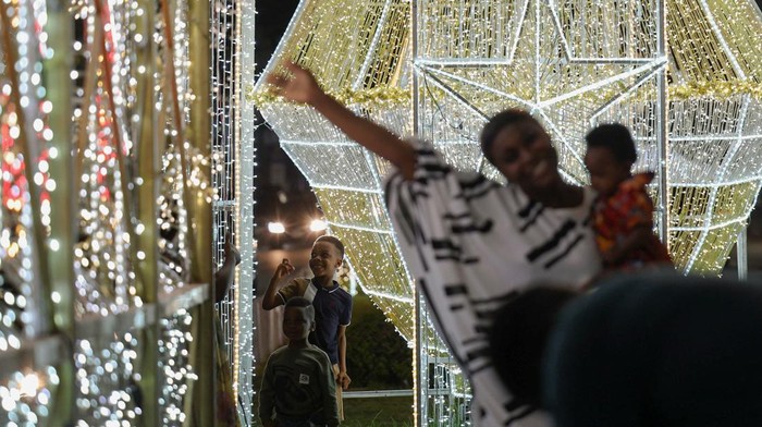 People walk past a Christmas light installation during a lighting ceremony in Lagos, Nigeria, December 7, 2025. REUTERS/Sodiq Adelakun