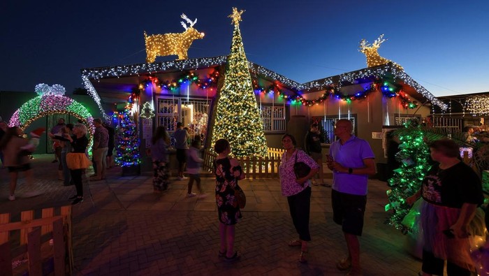 Visitors at Rick van der Galien's residence in Brackenfell, which he transformed with Christmas decorations and festive lights for visitors to view, near Cape Town, South Africa, December 8, 2025. REUTERS/Esa Alexander