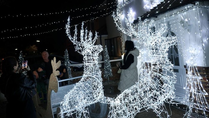 A house lit with Christmas lights display, decorated every year by Owen Gibbs to raise money for charity, in Feltham, Britain, December 10, 2025. REUTERS/Isabel Infantes     TPX IMAGES OF THE DAY