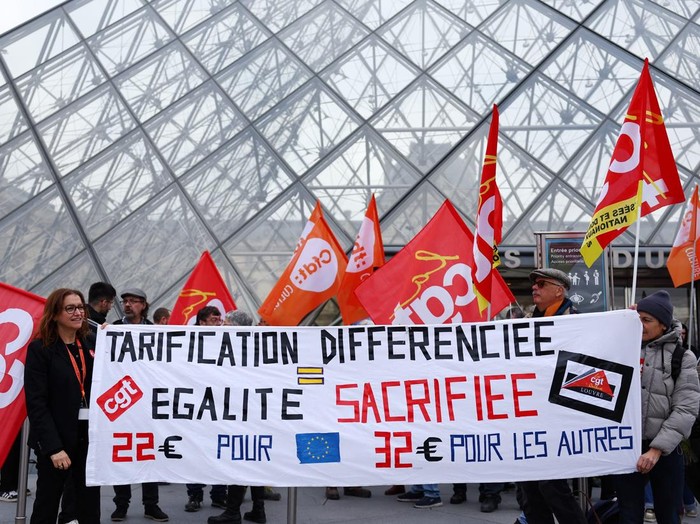 Louvre museum employees on strike gather in front the glass Pyramid to protest their working conditions at the museum, the state of the museums buildings and staffing issues, two months after a spectacular heist which saw thieves make off with jewels in broad daylight, outside the Louvre Museum in Paris, France, December 15, 2025. REUTERS/Benoit Tessier