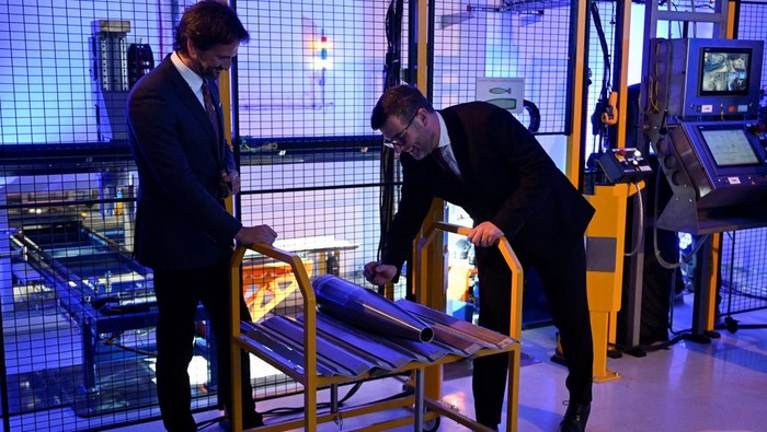 Employees operate a new filling line for artillery ammunition, known as the 