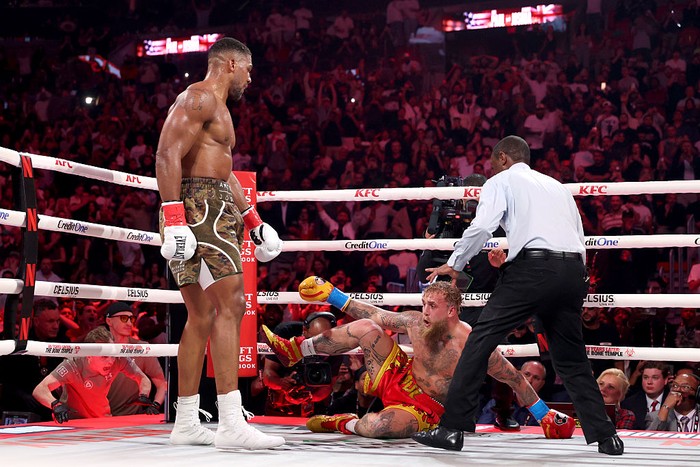 MIAMI, FLORIDA - DECEMBER 19: (L-R) Jake Paul fights Anthony Joshua in their heavyweight bout during Jake Paul v Anthony Joshua at Kaseya Center on December 19, 2025 in Miami, Florida. (Photo by Ed Mulholland/Getty Images for Netflix)