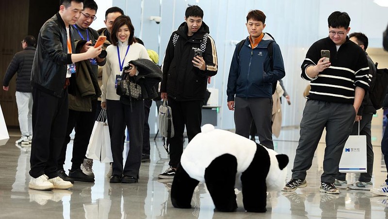 SHANGHAI, CHINA - DECEMBER 22: A humanoid robot interacts with visitors during the launch event of Botshare, or Qingtian Rental, on December 22, 2025 in Shanghai, China. China launches its first open robot rental platform, Qingtian Rental, in Shanghai. Covering 50+ cities, it offers humanoid robots for commercial and industrial use, with expansion to 200+ cities by 2026. (Photo by Tang Yanjun/China News Service/VCG via Getty Images)