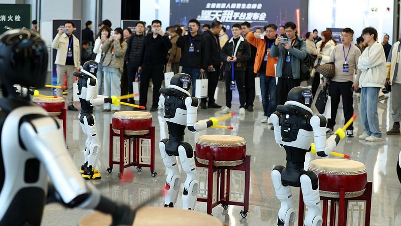 SHANGHAI, CHINA - DECEMBER 22: A humanoid robot interacts with visitors during the launch event of Botshare, or Qingtian Rental, on December 22, 2025 in Shanghai, China. China launches its first open robot rental platform, Qingtian Rental, in Shanghai. Covering 50+ cities, it offers humanoid robots for commercial and industrial use, with expansion to 200+ cities by 2026. (Photo by Tang Yanjun/China News Service/VCG via Getty Images)