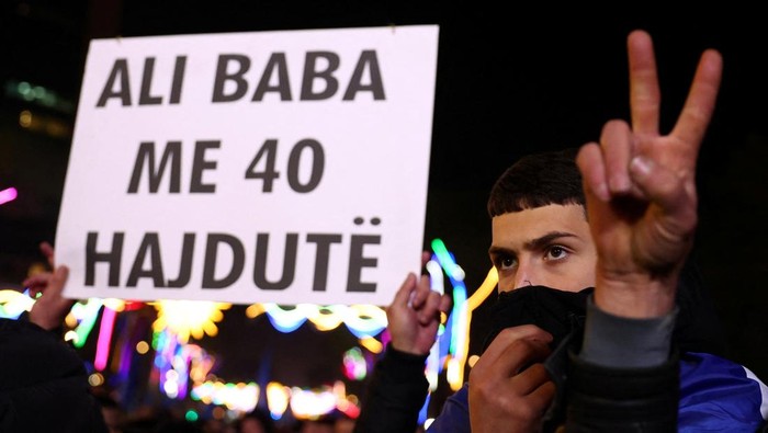 A supporter of the opposition holds up a sign during an anti-government protest, in Tirana, Albania, December 22, 2025. REUTERS/Florion Goga