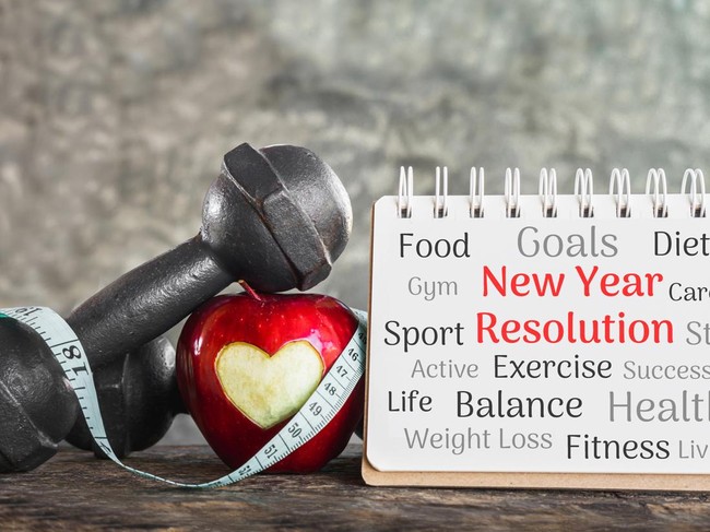 new year goals for sport concept with red apple,dumbbell and resolution list on paper