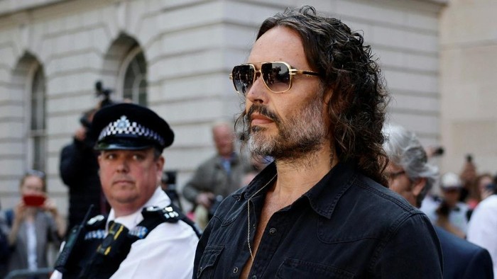 (FILES) British actor and comedian Russell Brand departs Westminster Magistrates Court in London on May 2, 2025. UK police said two new charges, of rape and sexual assault, had been issued on December 23, 2025 against British comedian and actor Russell Brand. (Photo by BENJAMIN CREMEL / AFP)
