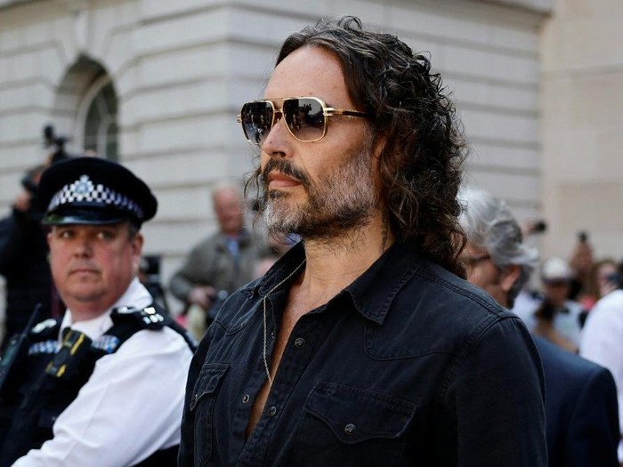 (FILES) British actor and comedian Russell Brand departs Westminster Magistrates Court in London on May 2, 2025. UK police said two new charges, of rape and sexual assault, had been issued on December 23, 2025 against British comedian and actor Russell Brand. (Photo by BENJAMIN CREMEL / AFP)
